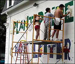 Painters working on the Plant Pride, Not Litter mural