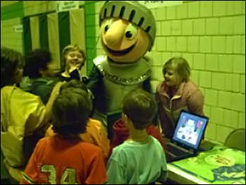 Kids and character at fair check out Ollie on the computer